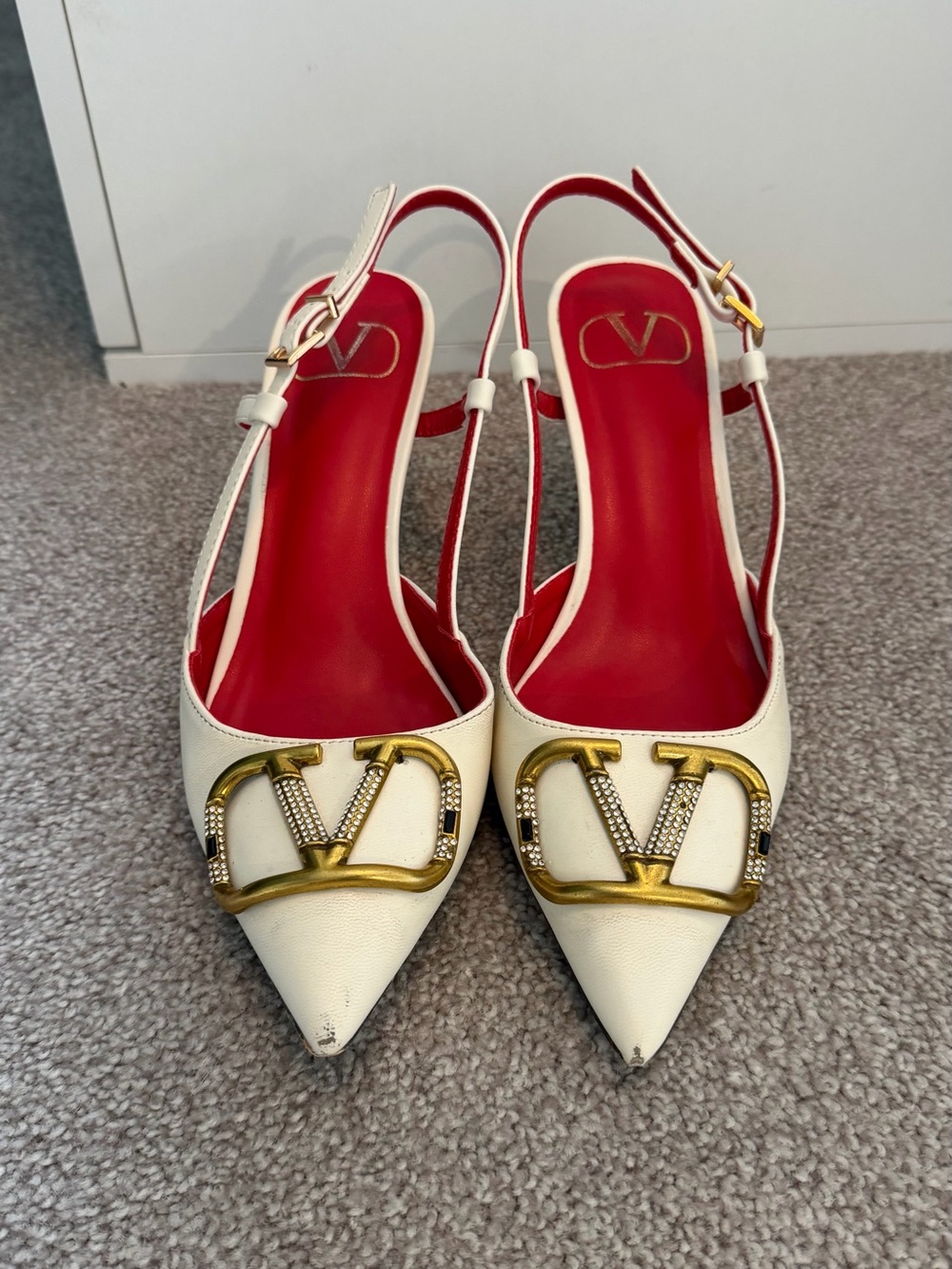 Valentino Garavani White Pointed Slingback Pumps with Gold V Logo and Red Insole